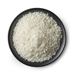 Bowl of coconut flakes on white background