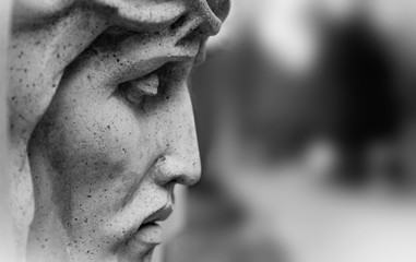 An ancient statue of the crucifixion of Jesus Christ in profile