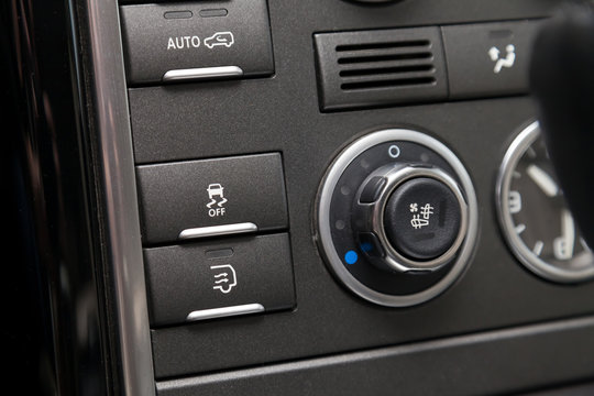 The button for the stability control system, side mirrors adjust headlight washer on black panel of car near the steering wheel to overcome off-road, impassable roads and drive safely in snow or rain