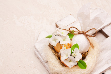 Abstract rabbit and golden eggs with flowers in the nest - easter composition. Copy space