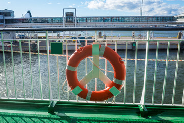 Lifebuoy on the railing of one of the decks of a tourist ferry