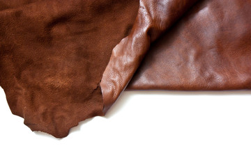 Leather in roll isolated on white background. Piece of brown leather isolated on white