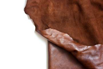 Leather in roll isolated on white background. Piece of brown leather isolated on white