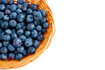 Ripe delicious blueberries close up in basket isolated on white background. Flat lay or top view. Space for text