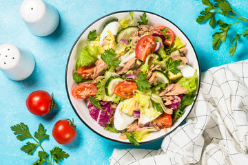Tuna salad with green leaves, eggs and vegetables.