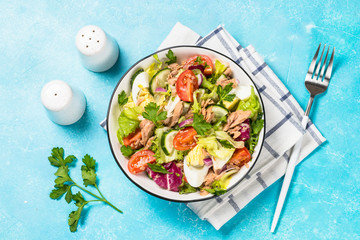 Tuna salad with green leaves, eggs and vegetables.