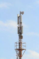 Base station mobile network antenna on a steel structure mast with a repeater.