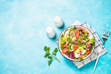 Tuna salad with green leaves, eggs and vegetables.