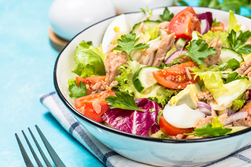 Tuna salad with green leaves, eggs and vegetables.