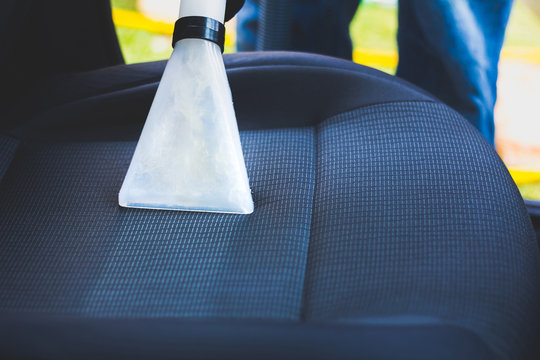 Man Does Car Upholstery Cleaning - Professional Chemical Cleaning With Suction Method. Hygienic Work And Stain Removal On The Vehicle Seat