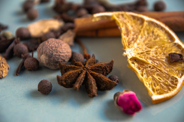 Dried oriental spices for making drinks on a home ceramic plate. Home kitchen.