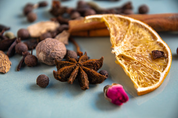 Dried oriental spices for making drinks on a home ceramic plate. Home kitchen.