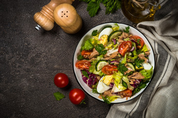 Tuna salad with green leaves, eggs and vegetables.