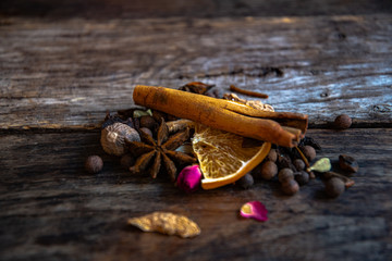 Dried oriental spices for the preparation of drinks on a wooden background.