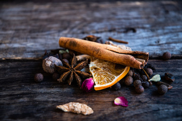 Dried oriental spices for the preparation of drinks on a wooden background.