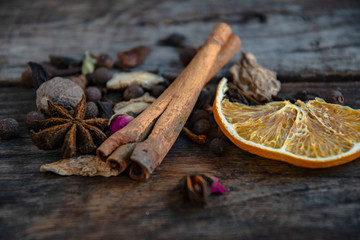 Dried oriental spices for the preparation of drinks on a wooden background.