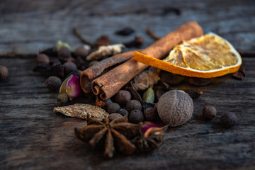 Dried oriental spices for the preparation of drinks on a wooden background.