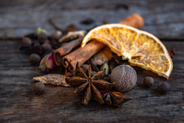 Dried oriental spices for the preparation of drinks on a wooden background.