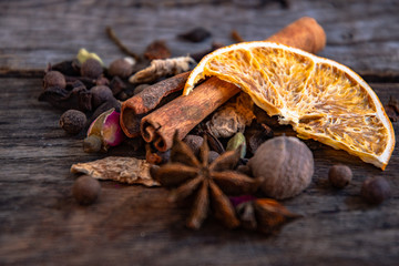 Dried oriental spices for the preparation of drinks on a wooden background.
