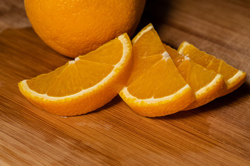 close-up of slices of sweet tasty aromatic orange lie on a wooden board