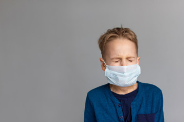 Caucasian sick boy wearing a protective mask. Contagious virus concept. Coronovirus concept.