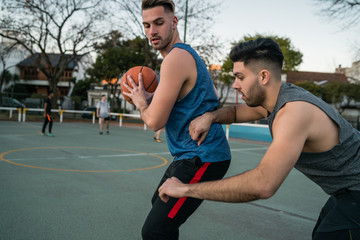 Fototapeta premium Young basketball players playing one-on-one.