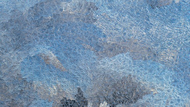 Frozen water on glass, texture abstract photo. Blue wallpaper