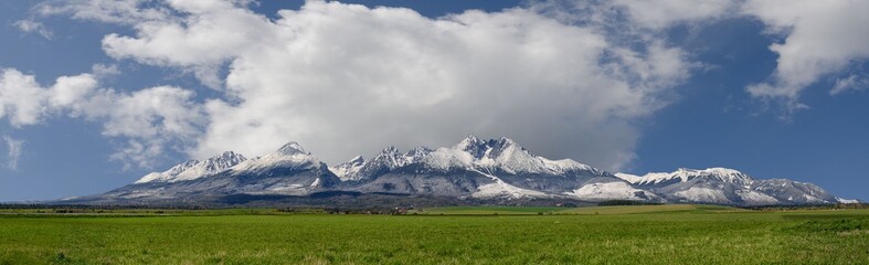 Extra wide panorama of High Tatra mountains with snowy hills Vysoke Tatry Slovakia, golden hours