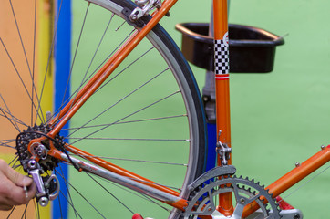 Bike service, mechanic serviceman, in workshop. Vintage race road bike, bicycle classic style