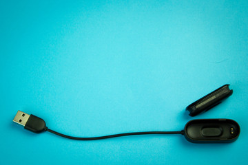 Black fitness watch (activity tracker) on a smartphone, health-saving technologies, modern technology concept, flat lay style place for text