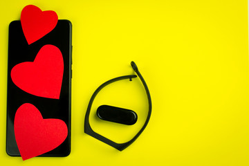 Black fitness watch (activity tracker) on a smartphone, health-saving technologies, modern...