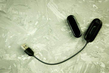 Black fitness watch (activity tracker) on a smartphone, health-saving technologies, modern...