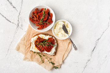 Healthy sandwich with soft cheese and spicy sun-dried tomatoes
