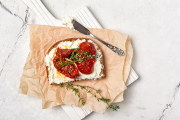 Healthy sandwich with soft cheese and spicy sun-dried tomatoes