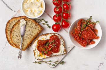 Healthy sandwiches with soft cheese and spicy sun-dried tomatoes