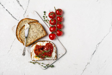 Healthy sandwiches with soft cheese and spicy sun-dried tomatoes