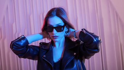 Beautiful girl dancing in retro wave on the neon light