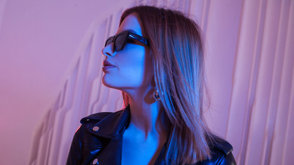 Beautiful girl dancing in retro wave on the neon light