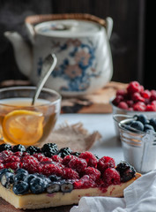 berry pies, raspberries, blueberries, and hot lemon tea. on a light table