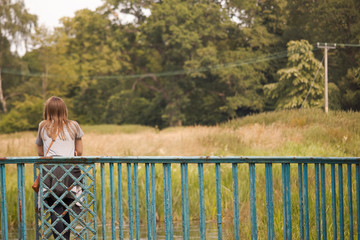 Young woman standing on bridge