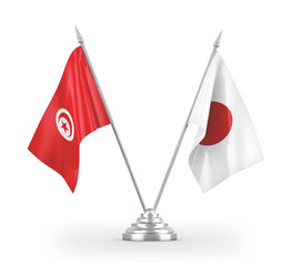 Obraz premium Japan and Tunisia table flags isolated on white 3D rendering