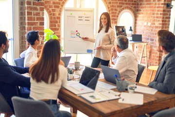 Group of business workers working together in a meeting. One of them making presentation to colleagues at the office