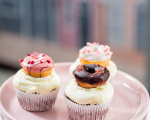 cupcakes with icing and small decorative donuts