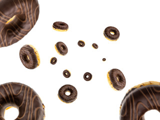 Colored donut. Glazed fresh chocolate cookies falling on white background. Dessert Chocolate snack