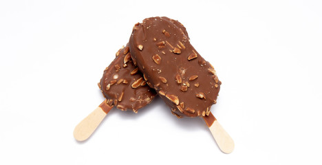 Chocolate ice cream with nuts on a stick. Isolated on a white background. Tasty dessert.