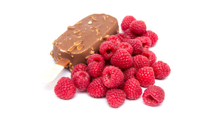 Chocolate ice cream with nuts, on a stick and a raspberry lying nearby. Concepts of healthy, tasty, nutrition. - Powered by Adobe