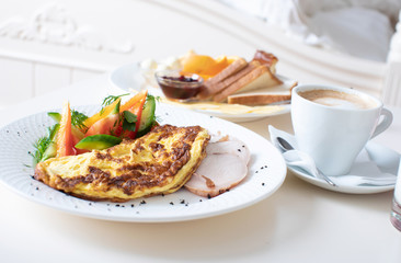 Close-up of tray with tasty breakfast on a bed.