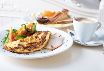Close-up of tray with tasty breakfast on a bed.
