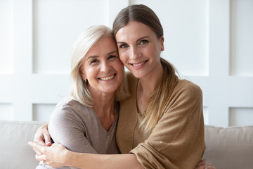 Headshot portrait of mature mom and adult daughter posing - obrazy, fototapety, plakaty