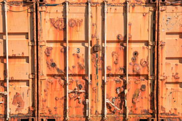 Old and Rusty door of a sea freight containers.